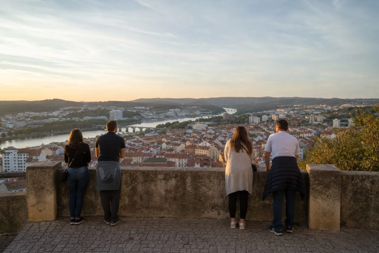 Evening view over terracotta rooftops of a Portuguese city and its river